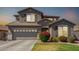 Charming two-story home with a well-maintained lawn and colorful landscaping at 2152 W Sunshine Butte Dr, San Tan Valley, AZ 85144