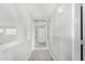 Upstairs hallway offers natural light and access to multiple rooms at 2152 W Sunshine Butte Dr, San Tan Valley, AZ 85144