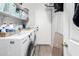 Laundry room with side-by-side washer and dryer and storage shelves at 2152 W Sunshine Butte Dr, San Tan Valley, AZ 85144