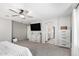 Bright main bedroom features a ceiling fan, an ensuite bathroom, and a walk-in closet at 2152 W Sunshine Butte Dr, San Tan Valley, AZ 85144
