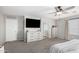 Main bedroom features a ceiling fan, an ensuite bathroom, and a walk-in closet at 2152 W Sunshine Butte Dr, San Tan Valley, AZ 85144
