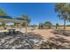 Community park playground with slides, climbing frames, picnic tables, and shaded area at 2152 W Sunshine Butte Dr, San Tan Valley, AZ 85144