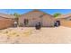 Backyard features rock landscaping, block fence, covered grill, and desert plants at 22534 W Pima St, Buckeye, AZ 85326