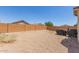 Expansive gravel backyard featuring a brick fence and shade with room for outdoor activities at 22534 W Pima St, Buckeye, AZ 85326