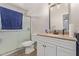 Bathroom featuring a shower, granite countertop, new sink and faucet, and updated lighting at 22534 W Pima St, Buckeye, AZ 85326