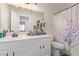 Bathroom features a single sink vanity, large mirror, and a unicorn-themed shower curtain at 22534 W Pima St, Buckeye, AZ 85326