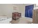 Bedroom featuring a dark wood crib, changing table, and soothing blue curtains at 22534 W Pima St, Buckeye, AZ 85326