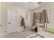 Bright bedroom with a twin bed, window, macrame wall art, and a whimsical decor at 22534 W Pima St, Buckeye, AZ 85326