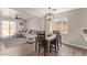 The dining area has hardwood floors, a chandelier and a window which brings in natural light at 22534 W Pima St, Buckeye, AZ 85326