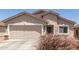 Inviting single-level home boasts desert landscaping, a two-car garage, and a charming covered entrance at 22534 W Pima St, Buckeye, AZ 85326