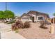 Single-story home with two car garage, desert landscaping, and close to neighboring houses at 22534 W Pima St, Buckeye, AZ 85326