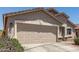 Two car garage door with stone accents, desert landscaping, and concrete driveway at 22534 W Pima St, Buckeye, AZ 85326