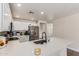Bright kitchen featuring a stainless steel fridge, granite counters, new faucet, and ample cabinet space at 22534 W Pima St, Buckeye, AZ 85326