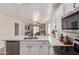 Bright kitchen featuring a stainless steel dishwasher, granite counters, new faucet, and ample cabinet space at 22534 W Pima St, Buckeye, AZ 85326