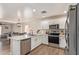 This kitchen features new stainless steel appliances and an island which overlooks the living area at 22534 W Pima St, Buckeye, AZ 85326