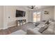 Comfortable living room featuring sectional sofa, gray area rug, and view to the backyard at 22534 W Pima St, Buckeye, AZ 85326