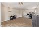 Bright, open living area with wood-look flooring, modern lighting, and neutral paint at 22534 W Pima St, Buckeye, AZ 85326