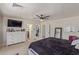 Spacious main bedroom featuring a ceiling fan, dresser, tv, and a mirror at 22534 W Pima St, Buckeye, AZ 85326