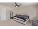This primary bedroom has a neutral carpet, ceiling fan and lots of room for furniture and activities at 22534 W Pima St, Buckeye, AZ 85326
