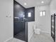 Elegant bathroom featuring a tiled shower with modern fixtures, toilet, towel warmer, and marble floors, offering spa-like ambiance at 22548 W Huntington Dr, Buckeye, AZ 85326