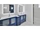 Chic bathroom featuring dual vanities, framed mirrors, marble floors, and modern fixtures, creating a stylish and functional space at 22548 W Huntington Dr, Buckeye, AZ 85326