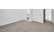 Spacious bedroom with neutral carpet, connecting bath, and closet at 22548 W Huntington Dr, Buckeye, AZ 85326