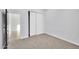Neutral carpeted bedroom with a closet with white sliding doors at 22548 W Huntington Dr, Buckeye, AZ 85326