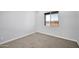 Cozy bedroom with neutral carpet and a window providing natural light at 22548 W Huntington Dr, Buckeye, AZ 85326