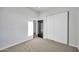 Bright bedroom with neutral carpet and large sliding closet at 22548 W Huntington Dr, Buckeye, AZ 85326