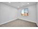 A bright, carpeted bedroom with a window and recessed lighting at 22548 W Huntington Dr, Buckeye, AZ 85326