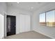 Comfortable bedroom with neutral carpet, large window, and closet at 22548 W Huntington Dr, Buckeye, AZ 85326