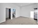 Bright bedroom featuring neutral carpet, ensuite bath, and closet at 22548 W Huntington Dr, Buckeye, AZ 85326