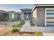 Close-up view of a stylish home entrance with a modern door and desert-friendly landscaping at 22548 W Huntington Dr, Buckeye, AZ 85326