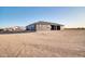 Exterior view showcasing the home's architecture and surrounding desert landscape at 22548 W Huntington Dr, Buckeye, AZ 85326