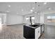 Open concept kitchen featuring an island with a sink, stainless dishwasher, pendant lighting, and wood-style flooring at 22548 W Huntington Dr, Buckeye, AZ 85326