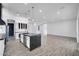 Spacious kitchen with stainless appliances, an island, pendant lighting, dark countertops, and open layout to living room at 22548 W Huntington Dr, Buckeye, AZ 85326