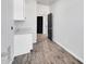 Well-lit laundry room with tile floors, cabinets, and granite countertops at 22548 W Huntington Dr, Buckeye, AZ 85326