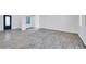 Open-concept living area with modern flooring, lots of natural light, and a stylish front door at 22548 W Huntington Dr, Buckeye, AZ 85326