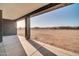 Relaxing covered patio offering views of the desert landscape, ideal for leisure and outdoor enjoyment at 22548 W Huntington Dr, Buckeye, AZ 85326