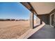 Covered patio area with a desert view, ideal for outdoor relaxation and entertainment at 22548 W Huntington Dr, Buckeye, AZ 85326