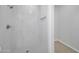 Modern bathroom with sleek white tiled shower with recessed shelving at 22548 W Huntington Dr, Buckeye, AZ 85326