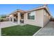 Home's outdoor space including patio, artificial turf, and seating area for relaxing at 24953 N 172Nd Dr, Surprise, AZ 85387