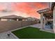 Well-maintained backyard with artificial turf and covered patio, ideal for entertaining at 24953 N 172Nd Dr, Surprise, AZ 85387