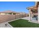 Well-maintained backyard with artificial turf and covered patio, ideal for entertaining at 24953 N 172Nd Dr, Surprise, AZ 85387