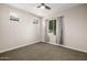 Bright bedroom with neutral walls, plush carpeting, and large windows dressed with curtains at 24953 N 172Nd Dr, Surprise, AZ 85387