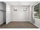 Neutral bedroom with carpet flooring, white trim, closet, and natural light from windows at 24953 N 172Nd Dr, Surprise, AZ 85387