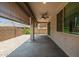 Large covered patio with ceiling fan offering shade and comfort for outdoor enjoyment at 24953 N 172Nd Dr, Surprise, AZ 85387