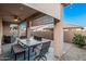 Inviting covered patio with ceiling fan, dining set, and comfortable seating area at 24953 N 172Nd Dr, Surprise, AZ 85387
