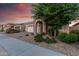 Charming single-story home with a brick-paved driveway and stone-accented entryway at 24953 N 172Nd Dr, Surprise, AZ 85387