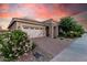 Charming single-story home with a brick-paved driveway and stone-accented entryway at 24953 N 172Nd Dr, Surprise, AZ 85387